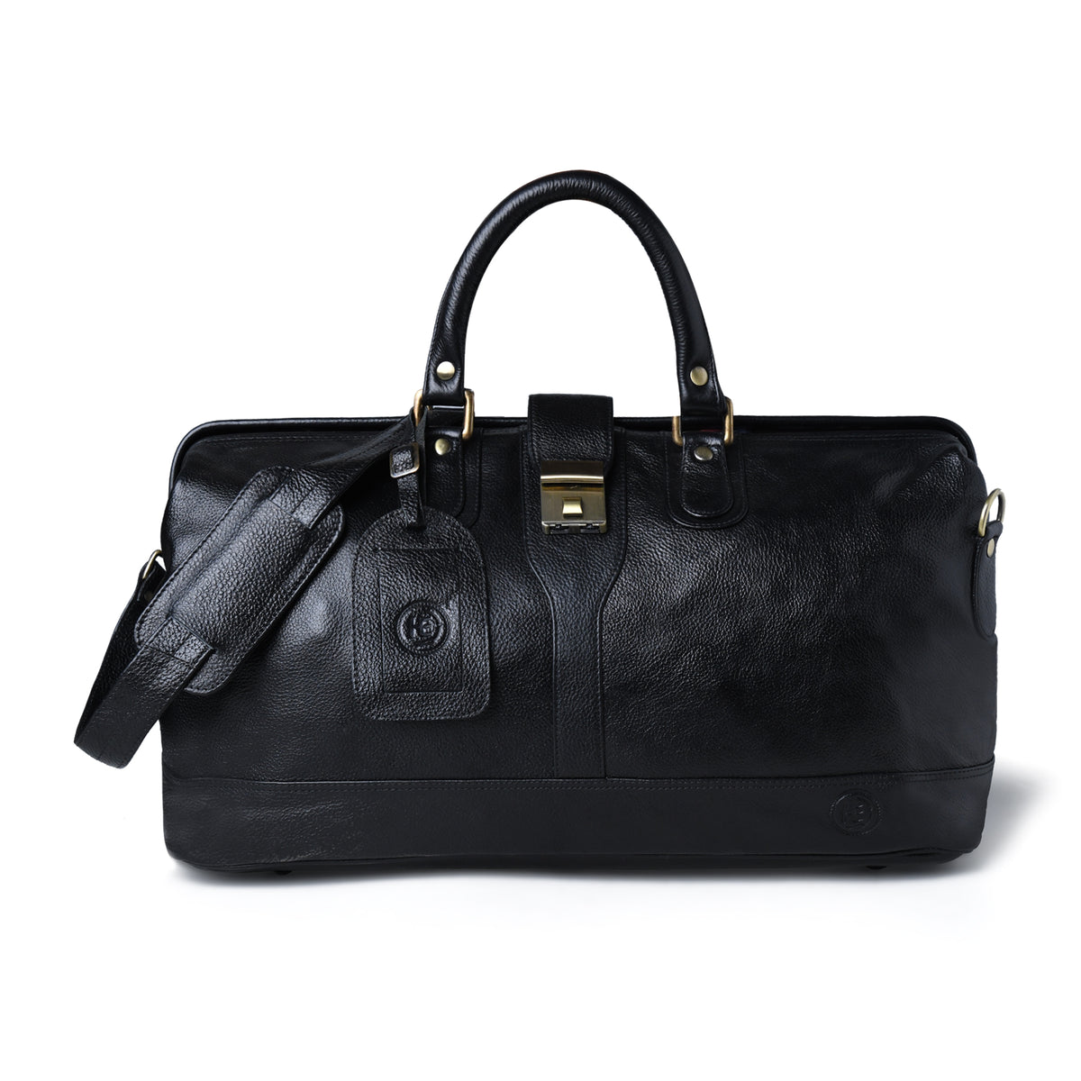 A black leather duffel bag with dual top handles, a detachable shoulder strap, a hanging luggage tag, and gold-tone hardware, photographed on a clean white background.