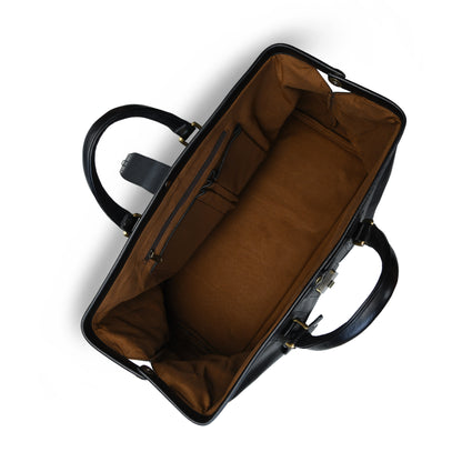 black leather briefcase or satchel, showing a rich brown fabric interior with zippered compartments and side pockets, set against a plain white background.