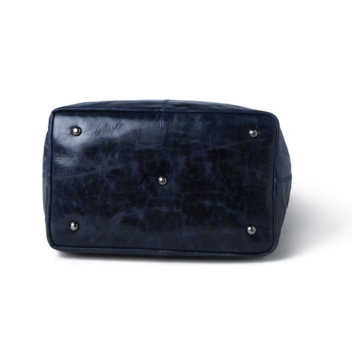 The bottom view of a dark navy leather bag with silver metal studs, shown on a white background.