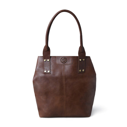 A dark brown leather tote bag with double shoulder straps, gold-tone rivets, and a circular logo medallion on the front, shown against a plain white background.