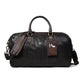 Dark Brown Leather Duffle Bag - front view with top handles, shoulder strap and luggage tag, handcrafted buffalo leather | Hema Emporium