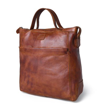 A brown distressed leather tote bag with dual top handles, a front slip pocket, and a small leather brand patch on the front, shown on a white background.