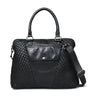 Black leather handbag with woven pattern on a light gray background
