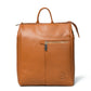 A tan Brown pebbled leather backpack with top handles, a front zippered pocket, and a circular embossed logo on the bottom right, shown on a white background.