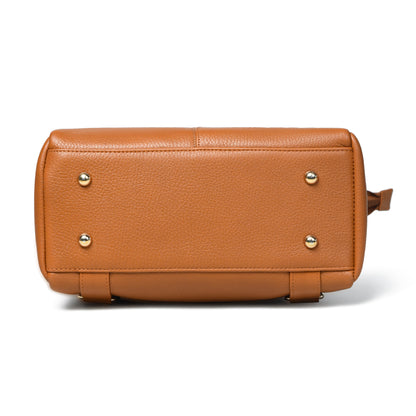 tan Brown pebbled leather handbag shown from the bottom back view, featuring four  metal studs on the front and a small leather pull tab on the right side, set against a plain white background.