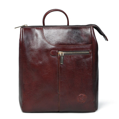 A burgundy leather backpack with a top handle, a front zippered pocket, and a circular embossed logo on the lower right, shown against a plain white background.